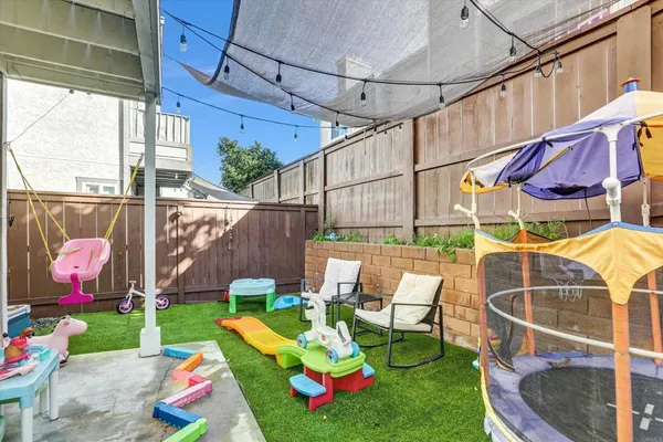 a view of yard with patio