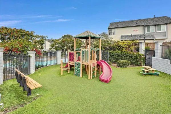 a view of a patio with a table and chairs