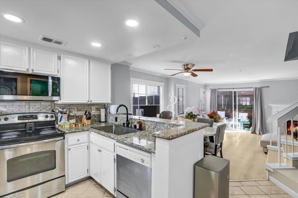 2102 Kings View Circle Spring Valley, CA 91977 - Photo 7 of 27 a open kitchen with stainless steel appliances granite countertop a stove and a sink