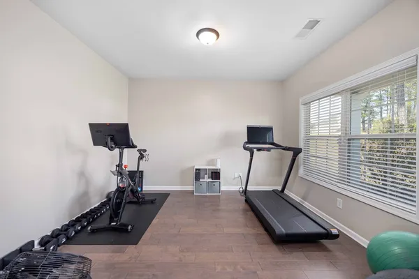 a room with gym equipment and a window