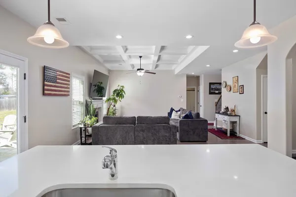 a living room with furniture and a chandelier