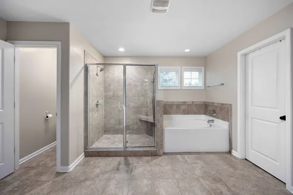 a bathroom with a bathtub and a shower