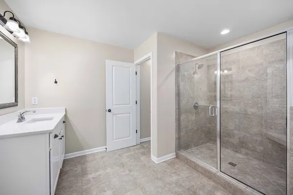 a bathroom with a shower sink and mirror