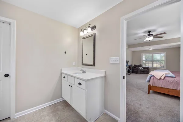 a en suite bathroom with a double vanity sink and a mirror