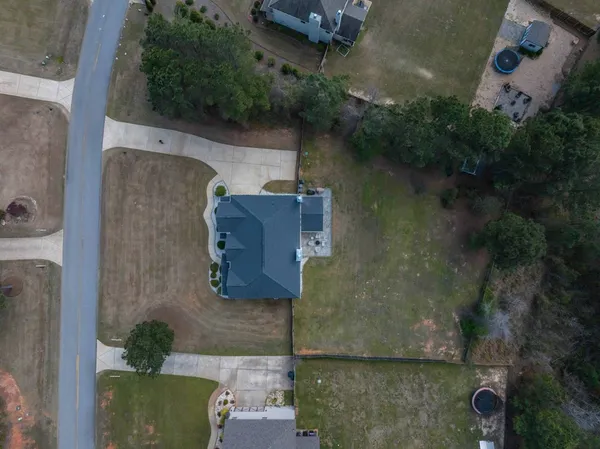 an aerial view of a house with outdoor space