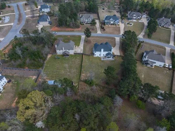 an aerial view of a house with a yard