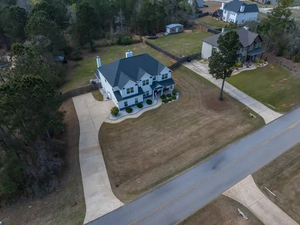 an aerial view of a house with a yard