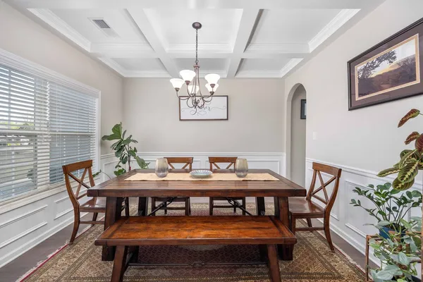 a view of a dining room with furniture and wooden floor