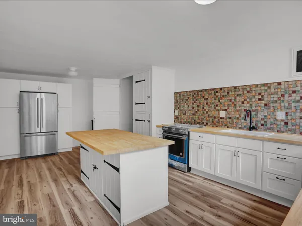 a view of empty room with window and hardwood floor