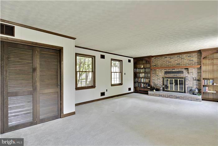 212 Indian Spring Drive Silver Spring, MD 20901 - Photo 11 of 22 a view of an empty room with furniture and a fireplace