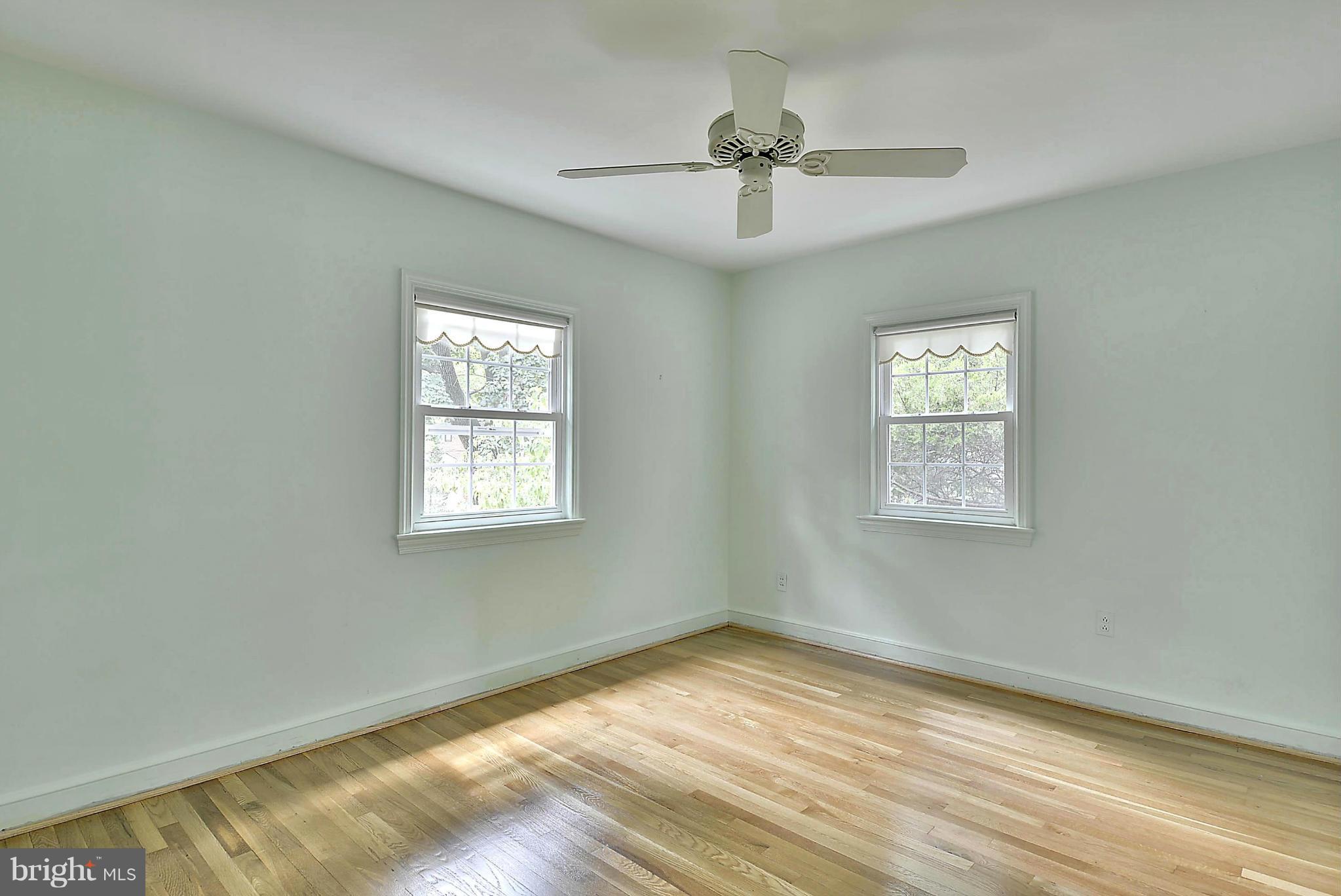 212 Indian Spring Drive Silver Spring, MD 20901 - Photo 14 of 22 a view of empty room with wooden floor and fan