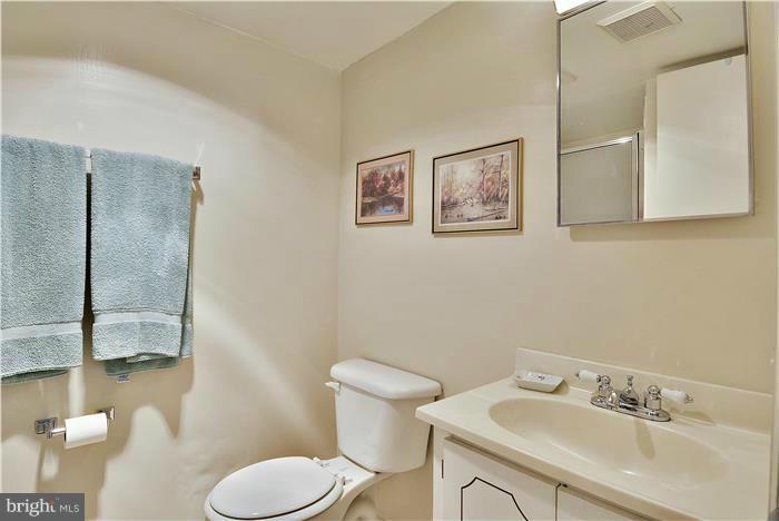 212 Indian Spring Drive Silver Spring, MD 20901 - Photo 18 of 22 a bathroom with a toilet sink and mirror