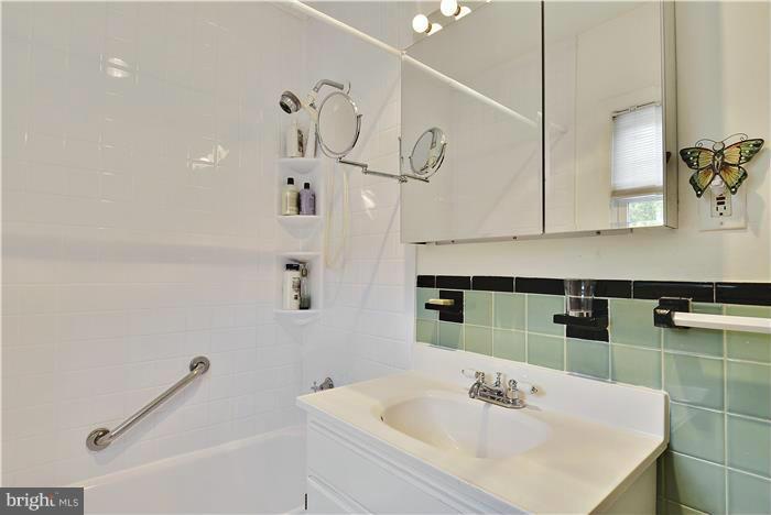 212 Indian Spring Drive Silver Spring, MD 20901 - Photo 19 of 22 a bathroom with a sink a mirror and a shower