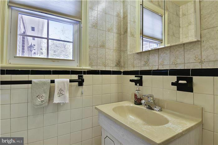 212 Indian Spring Drive Silver Spring, MD 20901 - Photo 20 of 22 a bathroom with a sink and a mirror