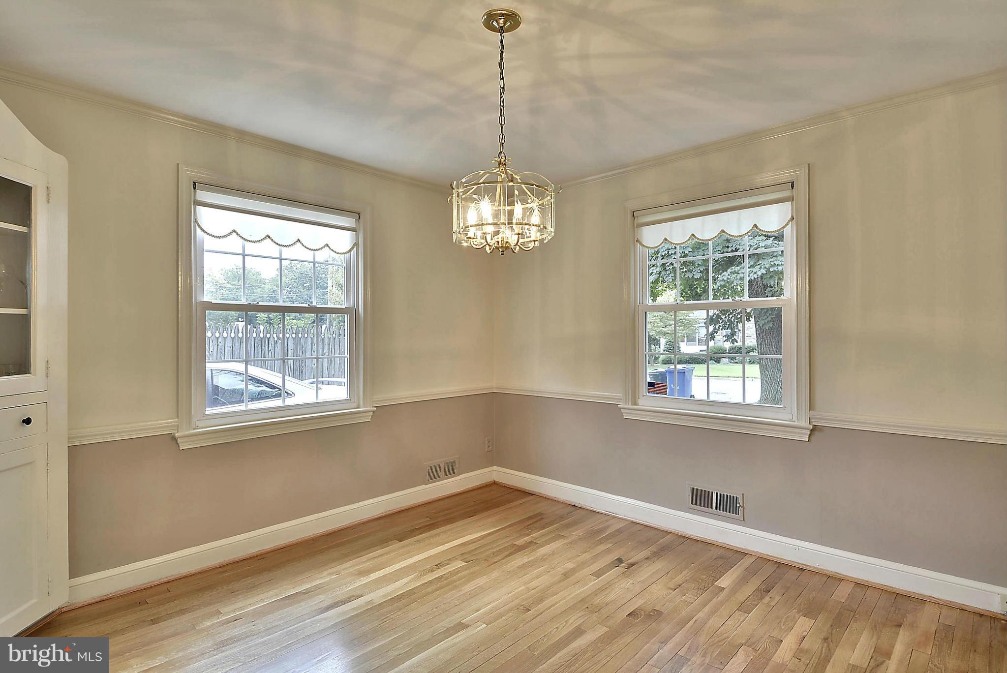212 Indian Spring Drive Silver Spring, MD 20901 - Photo 4 of 22 a view of an empty room with wooden floor and a window