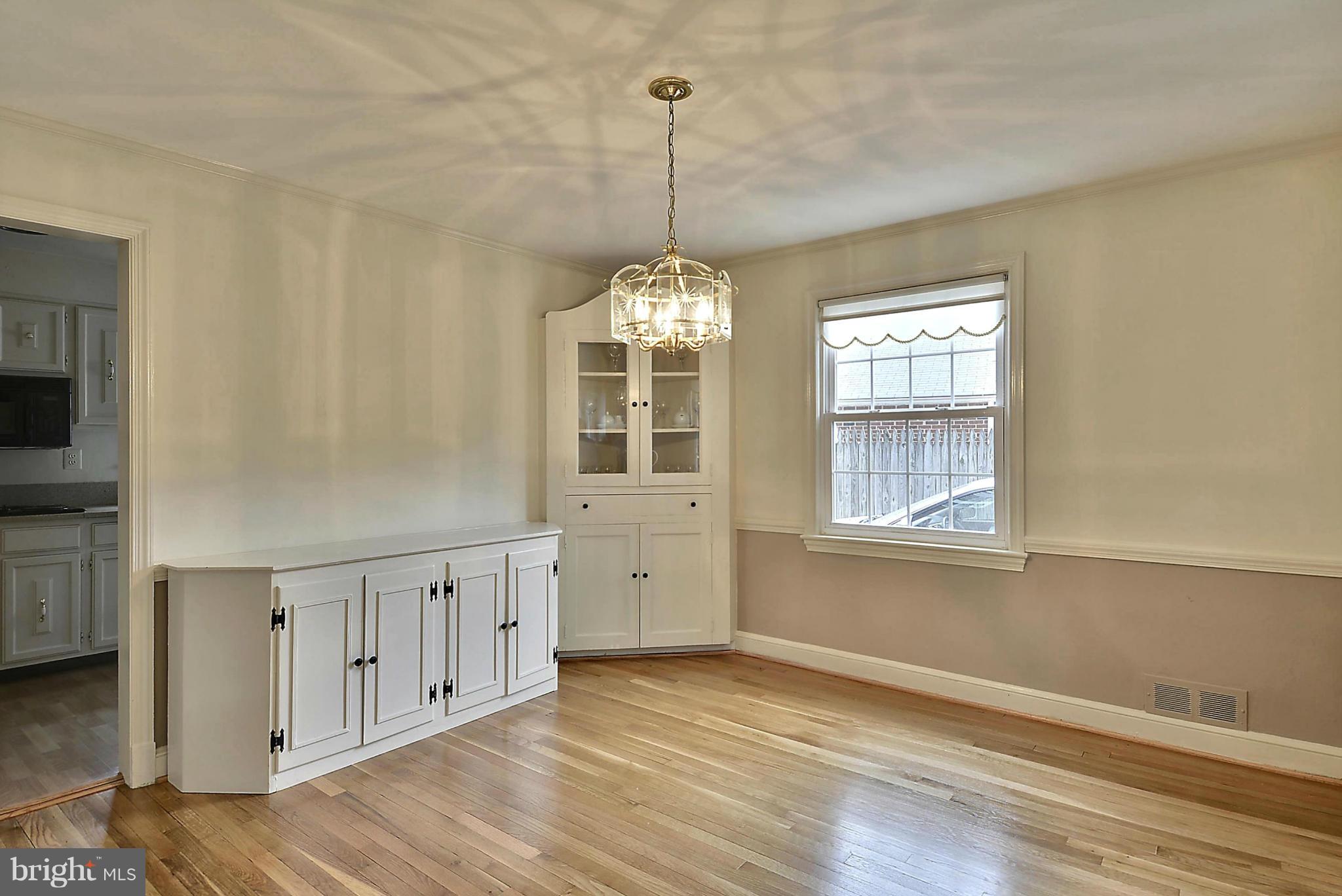 212 Indian Spring Drive Silver Spring, MD 20901 - Photo 5 of 22 a view of an empty room with window and wooden floor