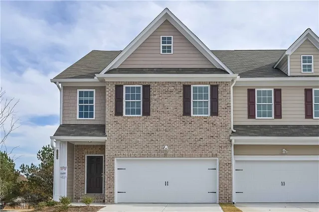 a front view of a house with garage