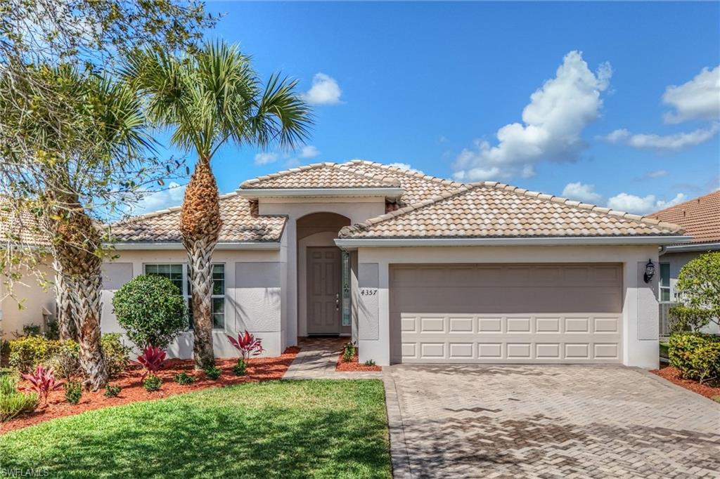 4357 Steinbeck Way Ave Maria, FL 34142 - Photo 1 of 40 a front view of a house with garden