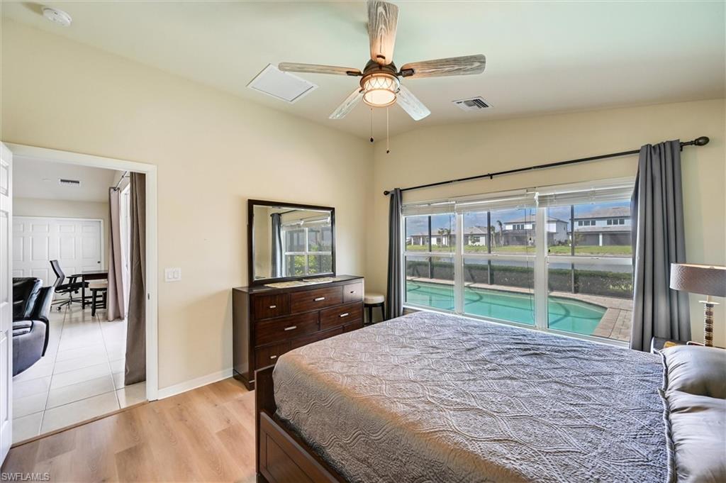 4357 Steinbeck Way Ave Maria, FL 34142 - Photo 10 of 40 a bedroom with a large bed and a chandelier