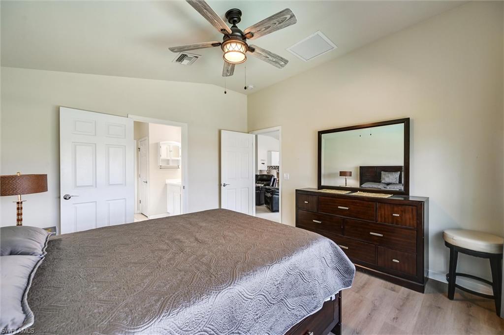 4357 Steinbeck Way Ave Maria, FL 34142 - Photo 12 of 40 a bedroom with a bed and a dresser