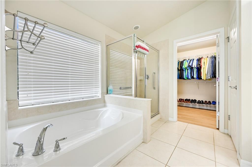 4357 Steinbeck Way Ave Maria, FL 34142 - Photo 14 of 40 a bathroom with a bathtub and a shower