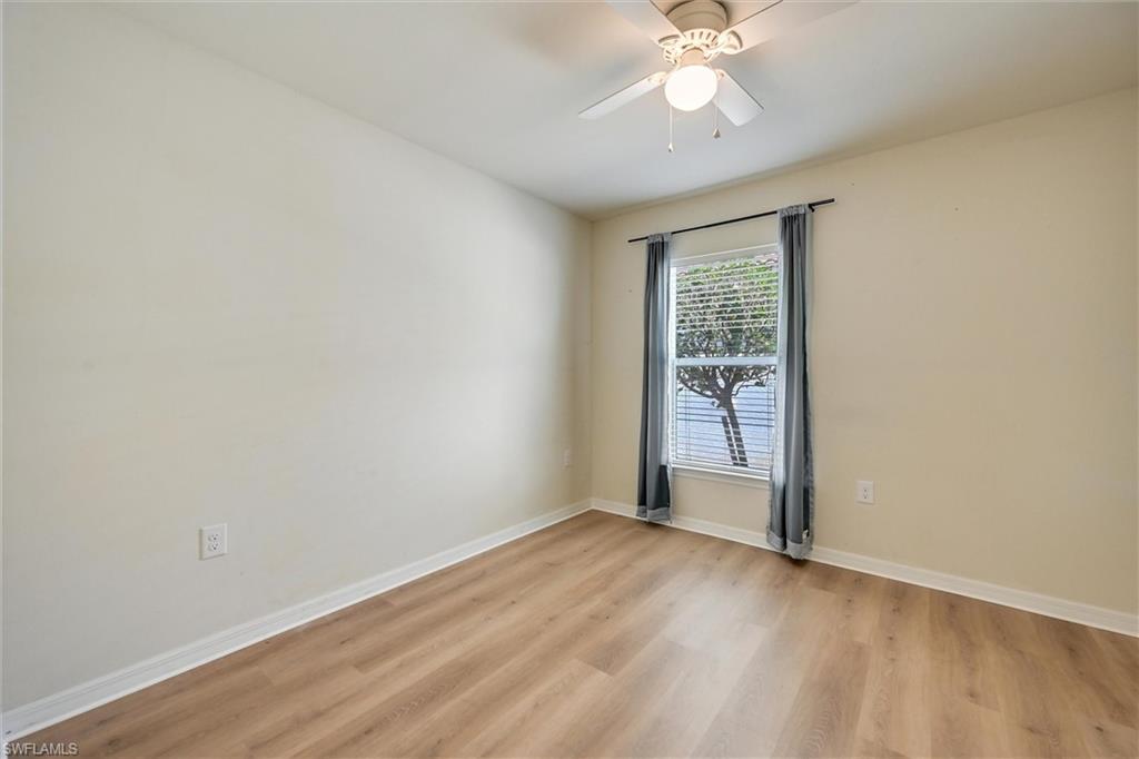 4357 Steinbeck Way Ave Maria, FL 34142 - Photo 20 of 40 an empty room with wooden floor fan and windows