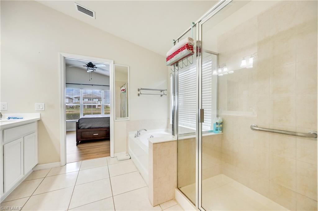 4357 Steinbeck Way Ave Maria, FL 34142 - Photo 28 of 40 a bathroom with a tub and a shower