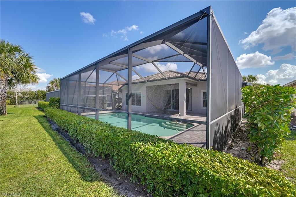 4357 Steinbeck Way Ave Maria, FL 34142 - Photo 32 of 40 a view of a house with a yard and plants
