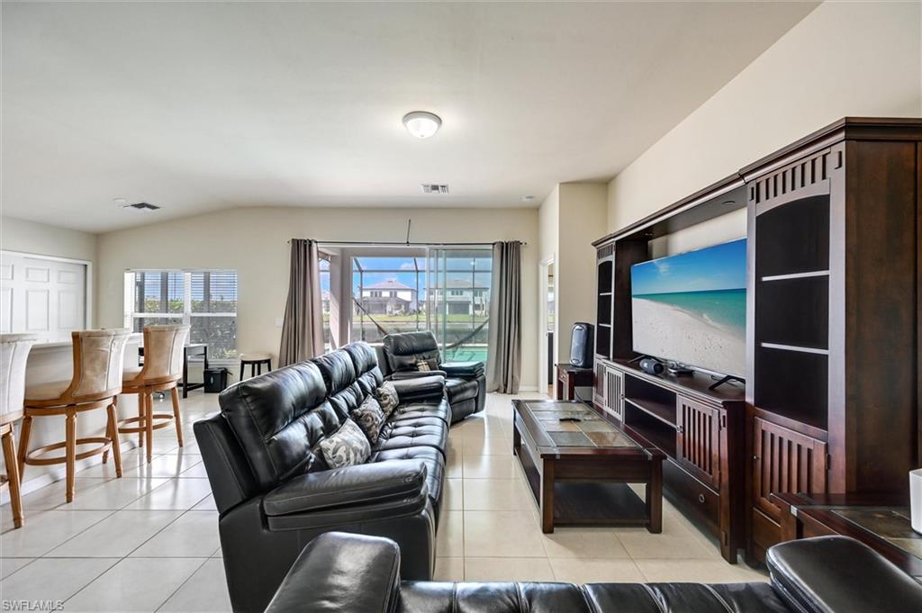 4357 Steinbeck Way Ave Maria, FL 34142 - Photo 7 of 40 a living room with furniture and a flat screen tv
