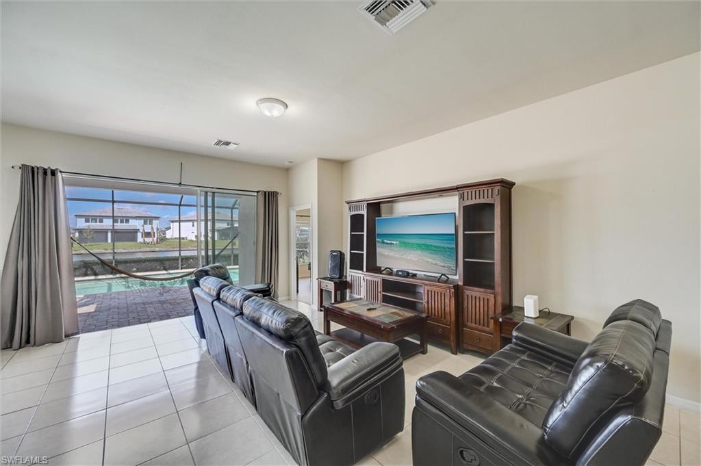 4357 Steinbeck Way Ave Maria, FL 34142 - Photo 8 of 40 a living room with furniture and a flat screen tv