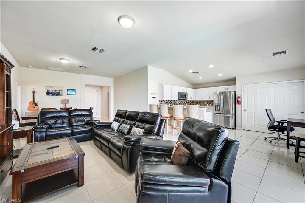 4357 Steinbeck Way Ave Maria, FL 34142 - Photo 9 of 40 a living room with furniture a table and chairs