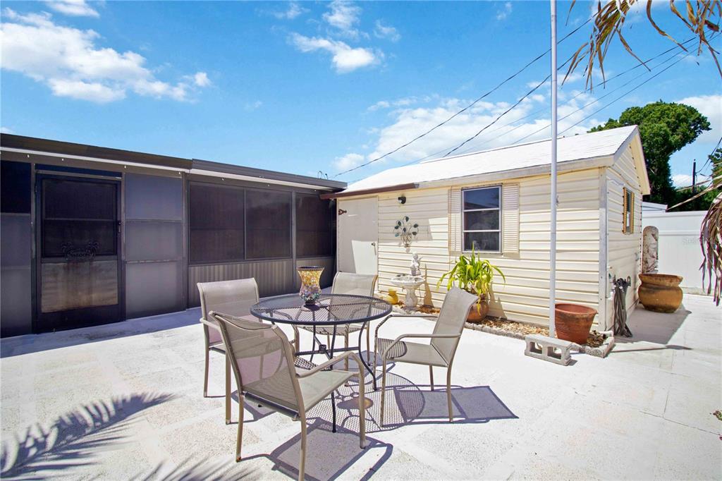 1028 Lillian Street Venice, FL 34285 - Photo 28 of 30 a view of a patio with a table and chairs and potted plants