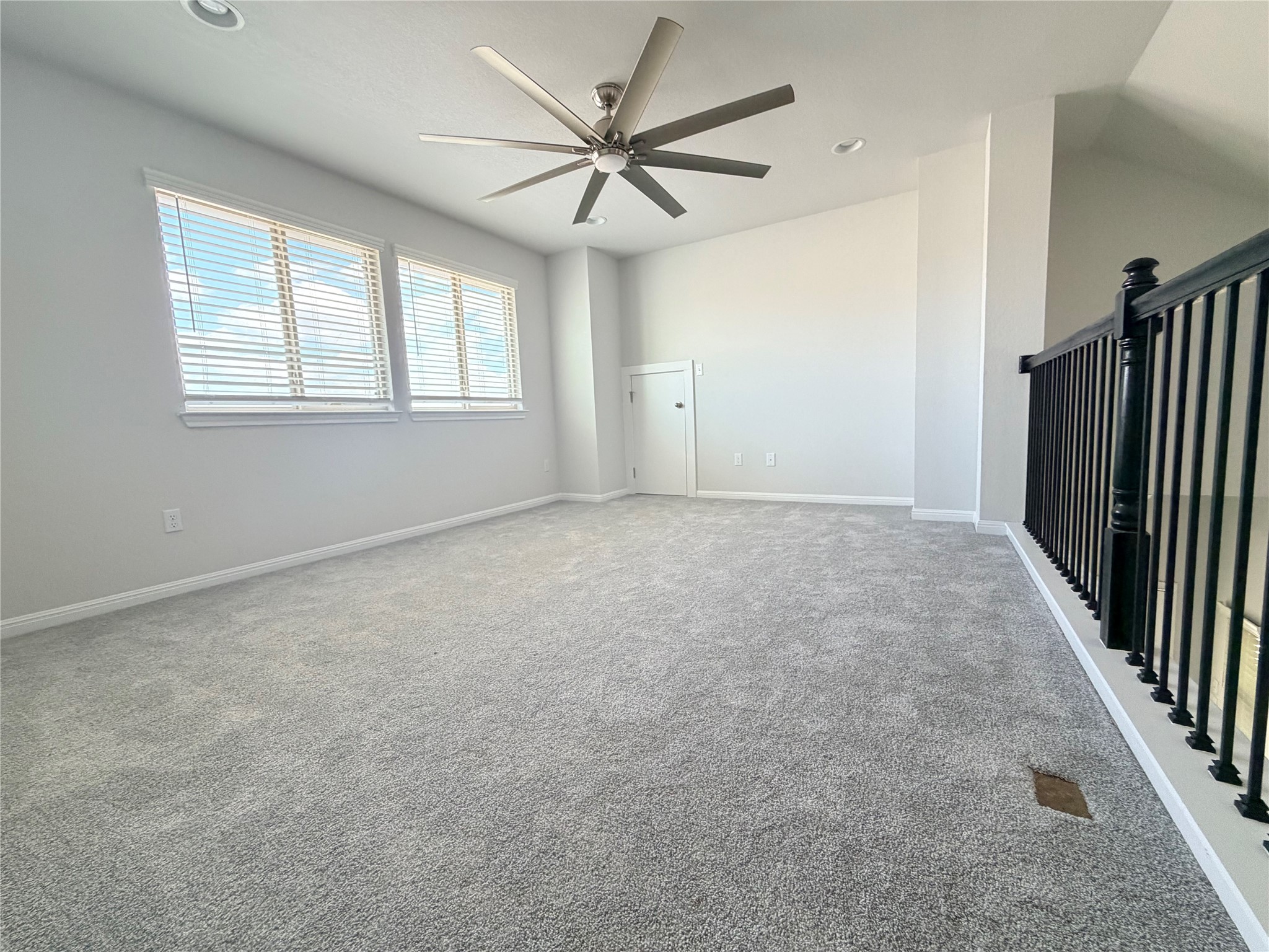 2813 Hopi Path, Unit 11 Leander, TX 78641 - Photo 10 of 17 Carpeted spare room with a ceiling fan and recessed lighting