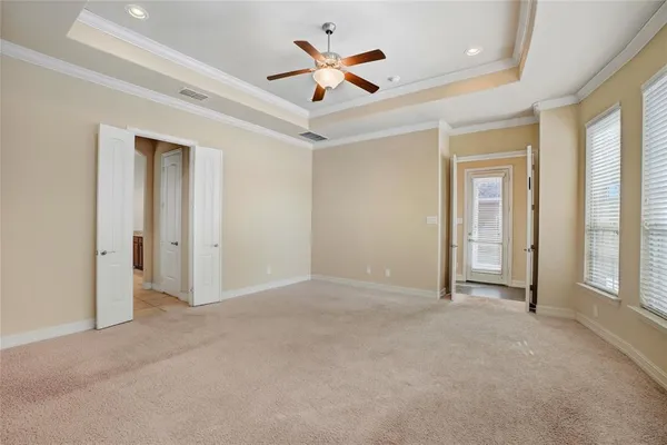 an empty room with ceiling fan and window
