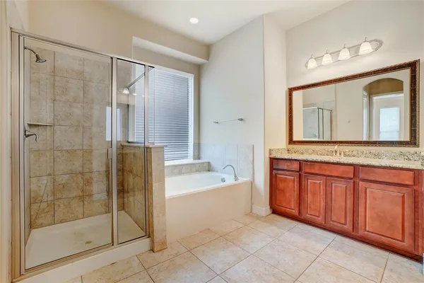 a bathroom with a bathtub sink and a mirror