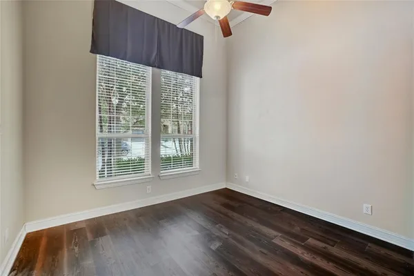 a view of wooden floor and windows in a room