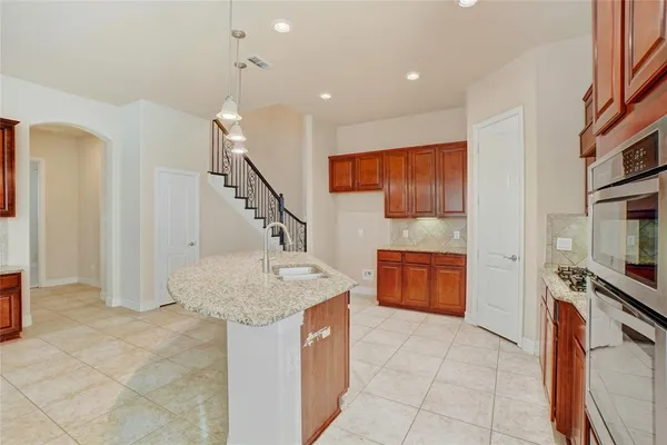 a view of kitchen with microwave and cabinets