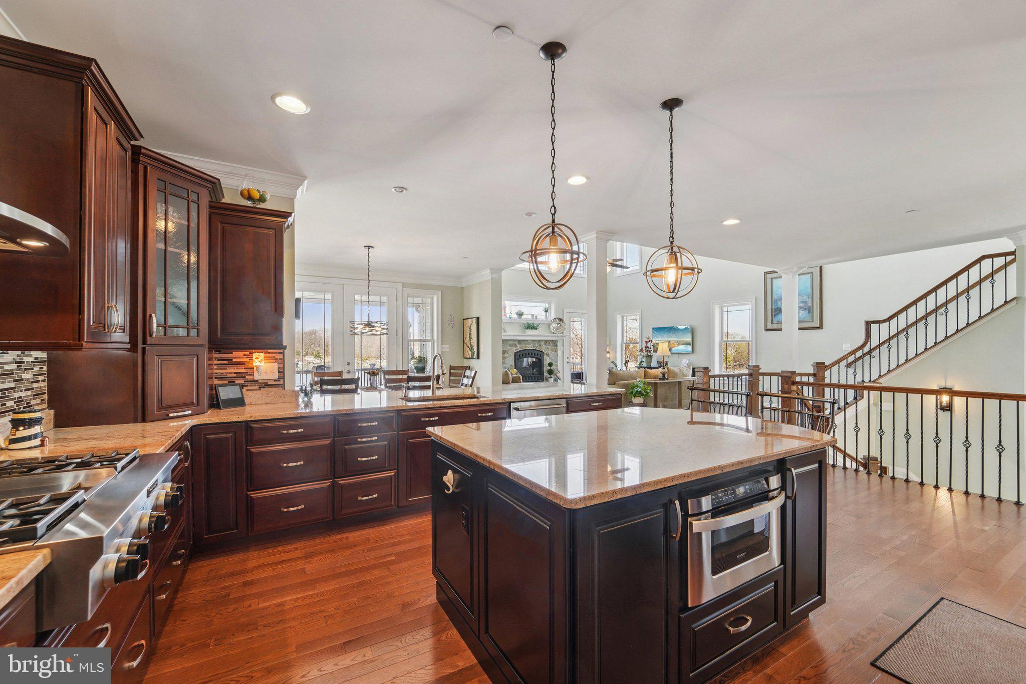 424 Katherine Avenue Baltimore, MD 21221 - Photo 28 of 77 a large kitchen with stainless steel appliances granite countertop a stove and a large countertops with wooden floor