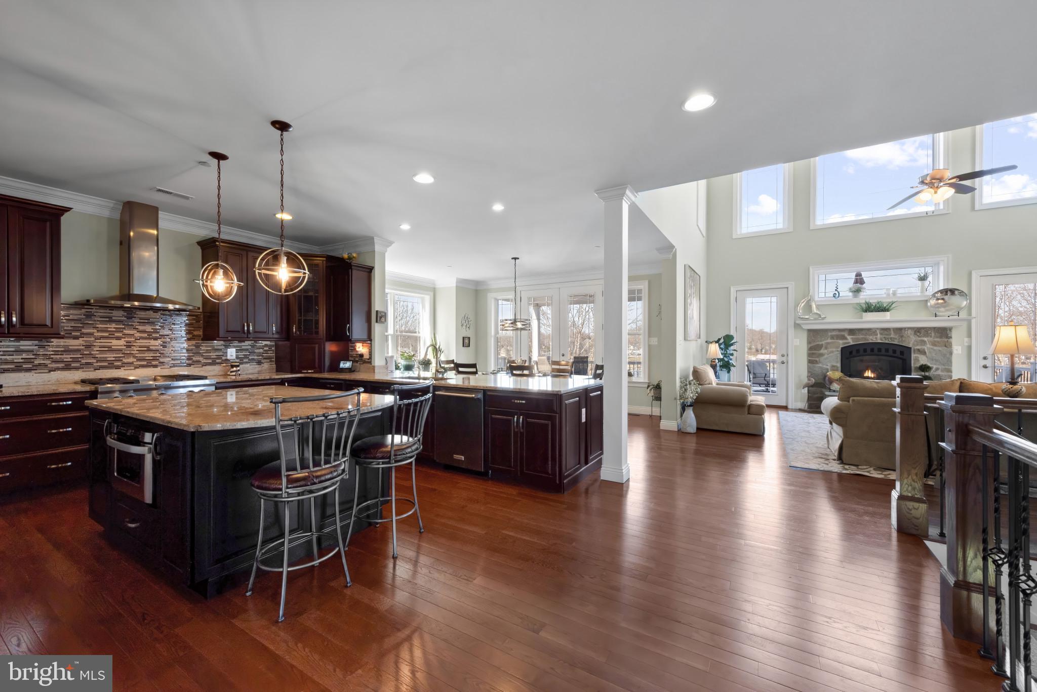424 Katherine Avenue Baltimore, MD 21221 - Photo 29 of 77 a kitchen with stainless steel appliances granite countertop a stove a refrigerator a kitchen island a couch and a dining table