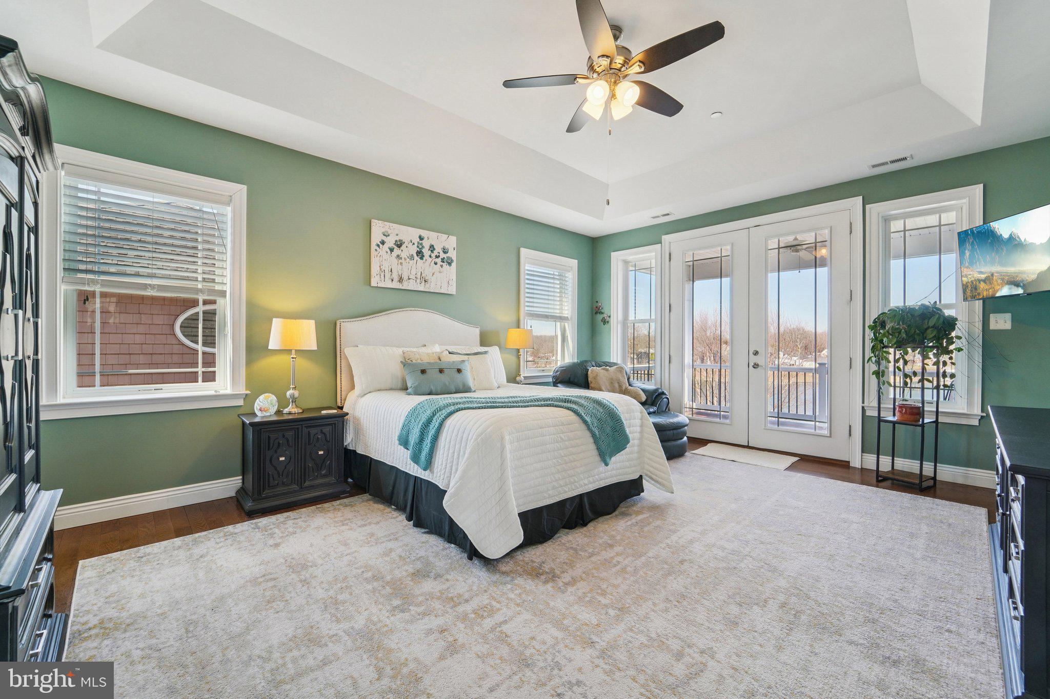424 Katherine Avenue Baltimore, MD 21221 - Photo 42 of 77 a spacious bedroom with a bed a chandelier and a large window