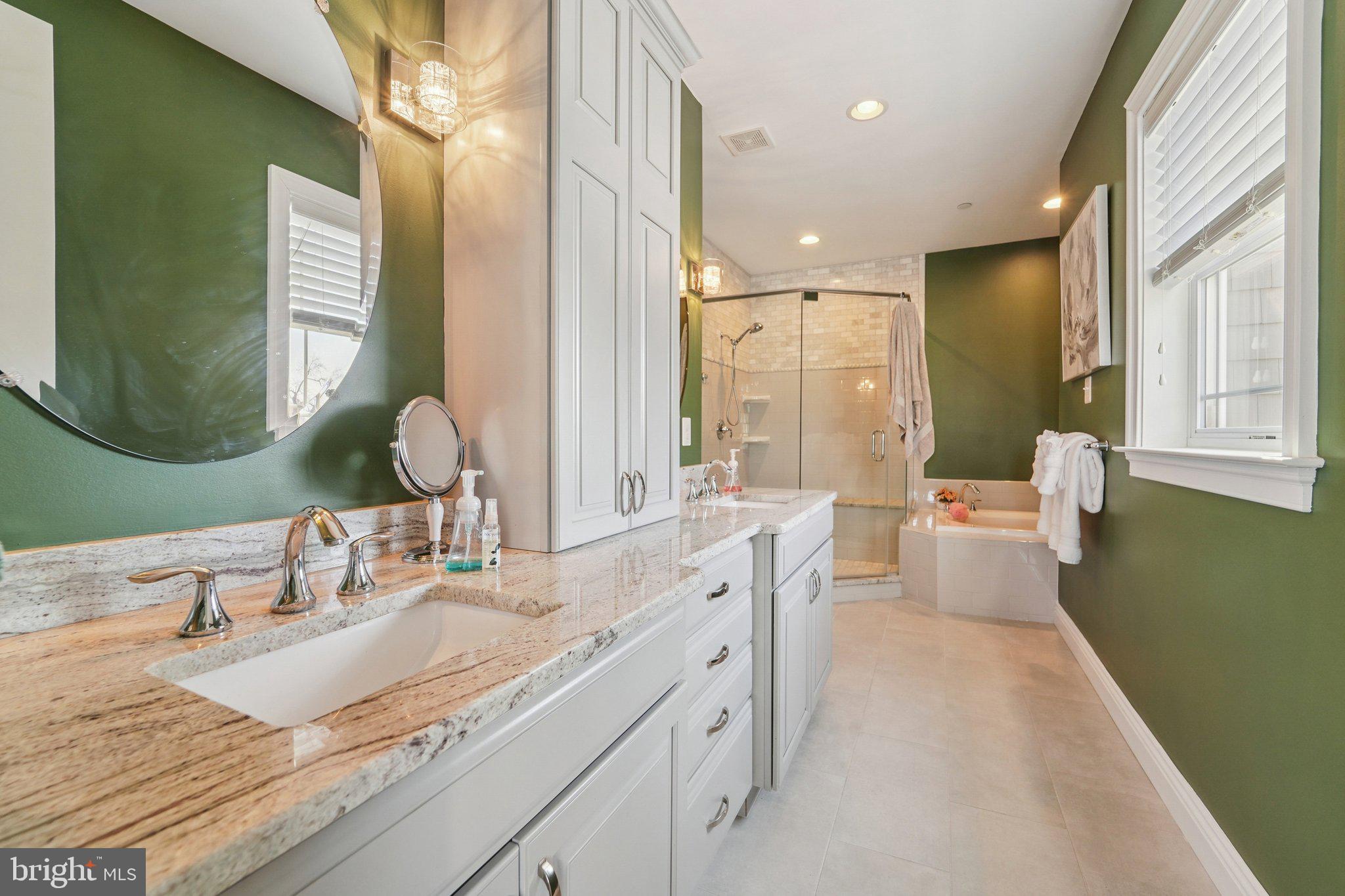 424 Katherine Avenue Baltimore, MD 21221 - Photo 44 of 77 a bathroom with a granite countertop sink a large mirror and a bathtub
