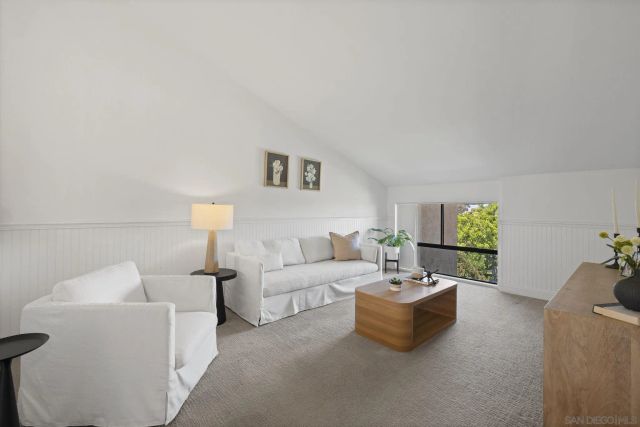 a living room with furniture and a lamp