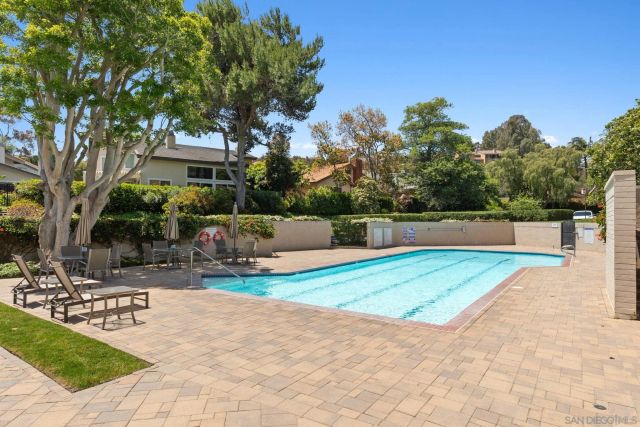 a view of backyard with a table and chairs under an umbrella