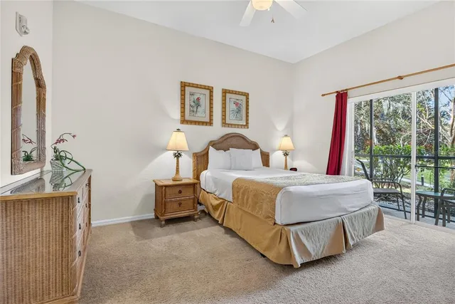 a bedroom with a bed lamp and a large window