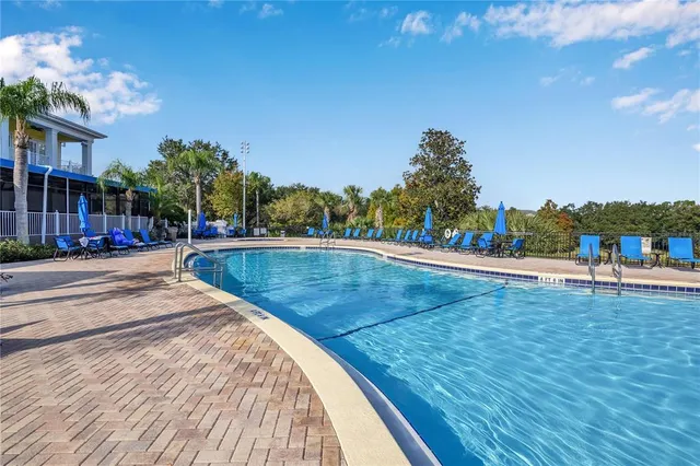 a view of a swimming pool with an outdoor space and seating area