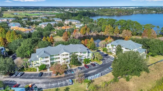 an aerial view of residential houses with outdoor space and river