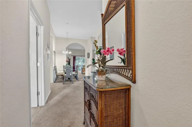 a hallway with beautiful frames and flower vase
