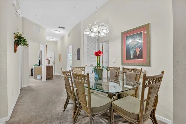a view of a dining room with furniture and chandelier