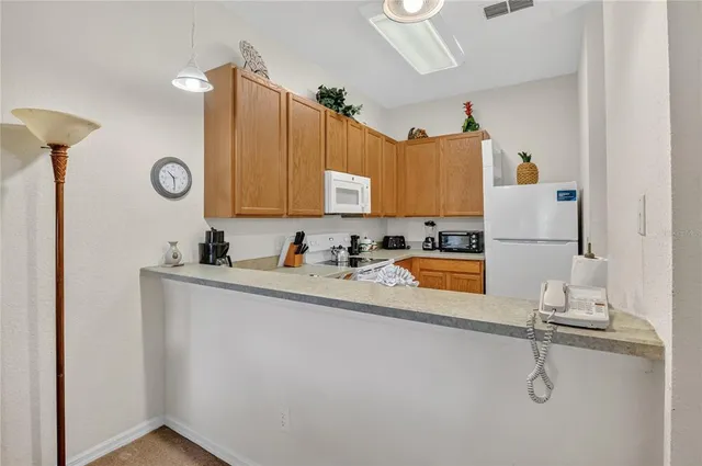 a kitchen with a refrigerator and a sink