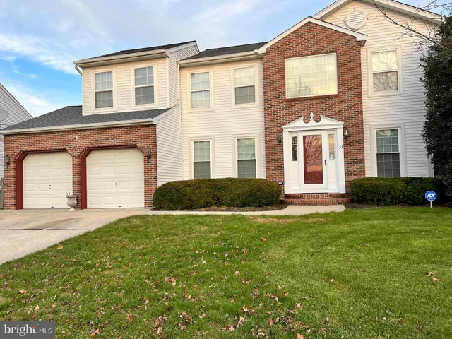 a large house with a big yard and more windows